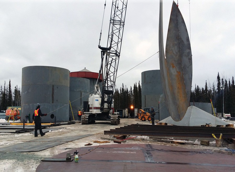 Lifting part of a steel storage tank during construction