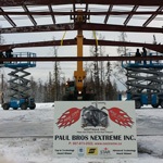Paul Bros sign in front of partially built steel building